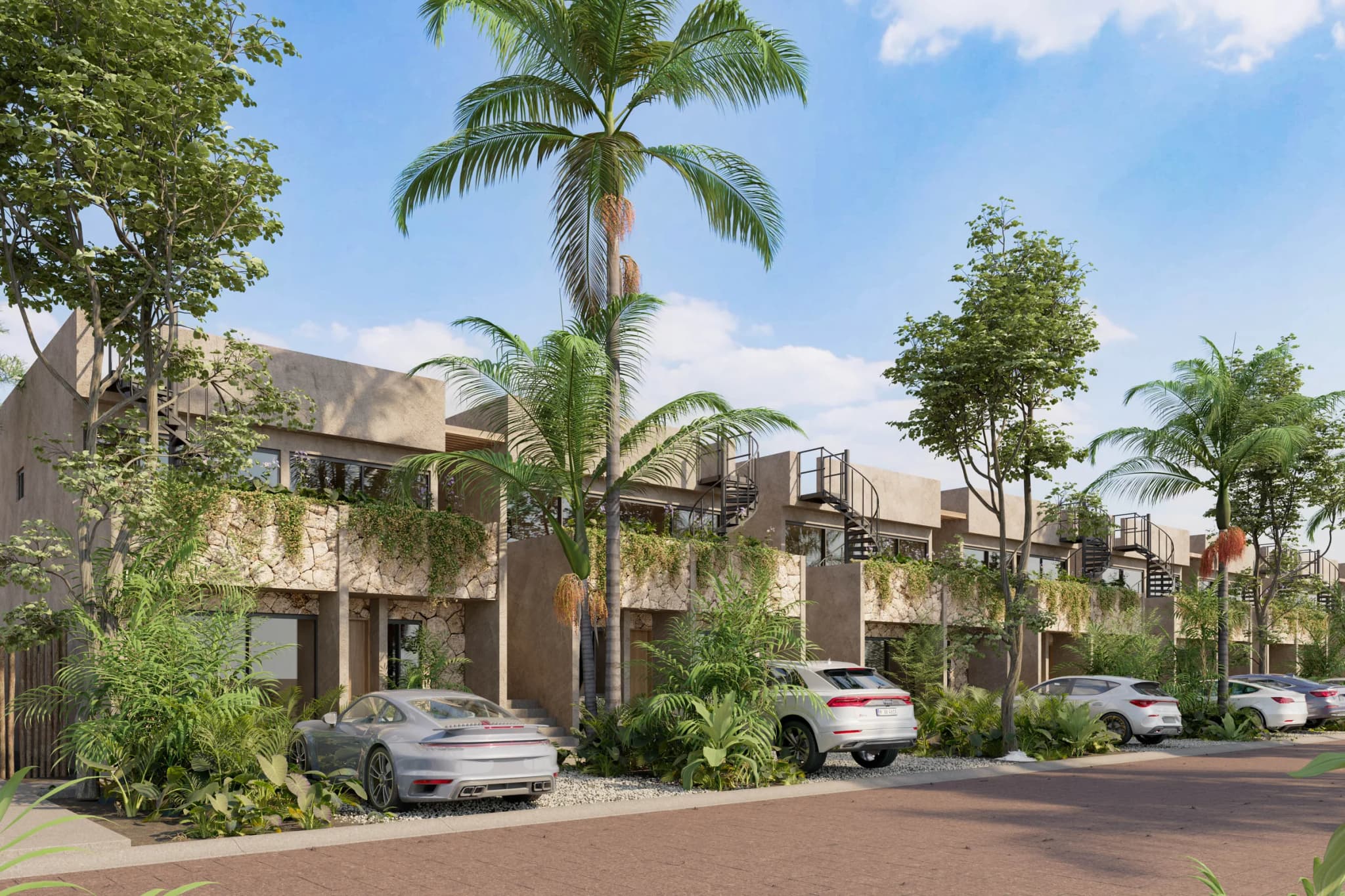 Kaoni's two-storey buildings, with spiral stairs up to the rooftops, palm trees and cars parked along the internal street