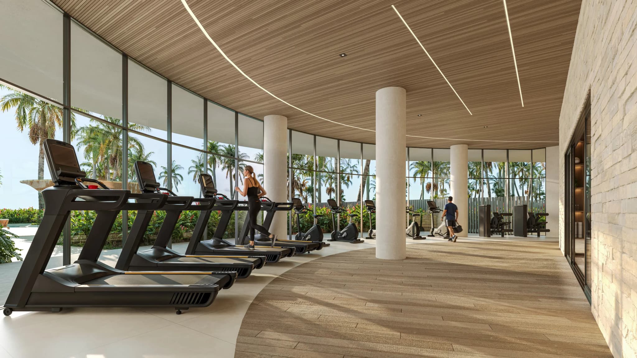 Gimnasio con ventanales hacia el jardín