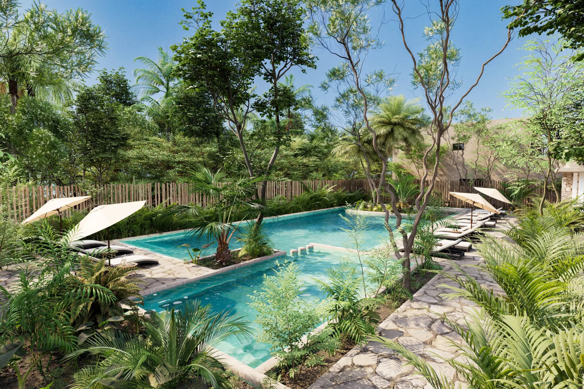 Pool surrounded by tropical planting, with umbrellas and loungers on a wooden deck